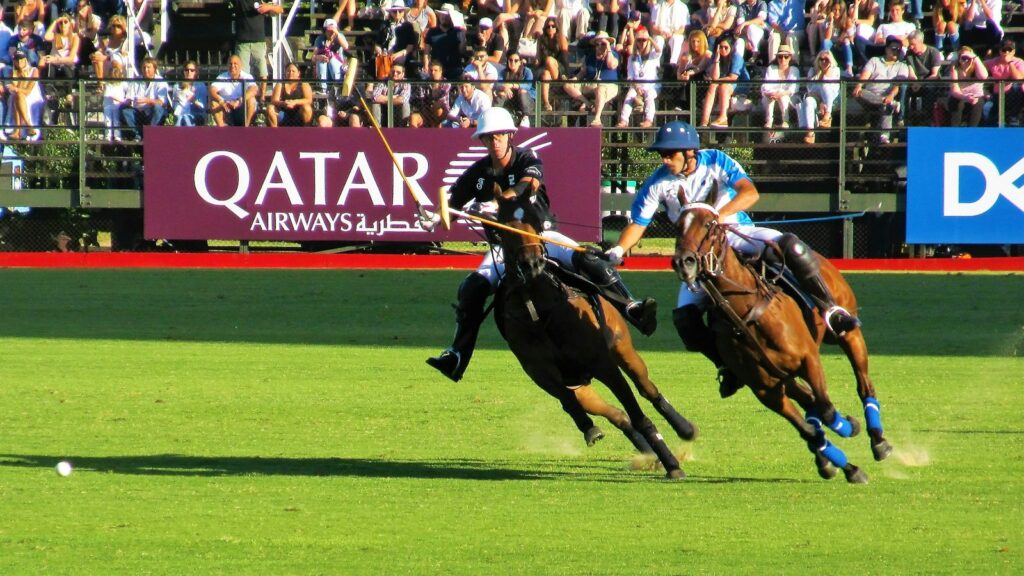 two person riding horse during daytime