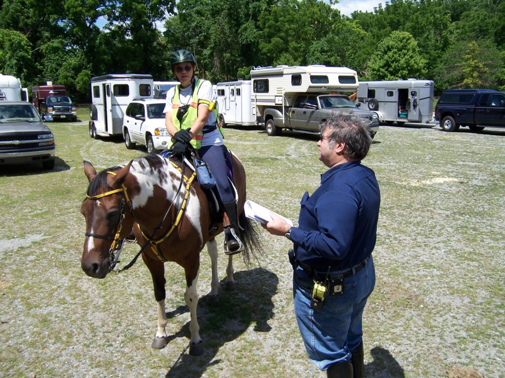 Mounted SAR field team member being briefed by SAR ops.