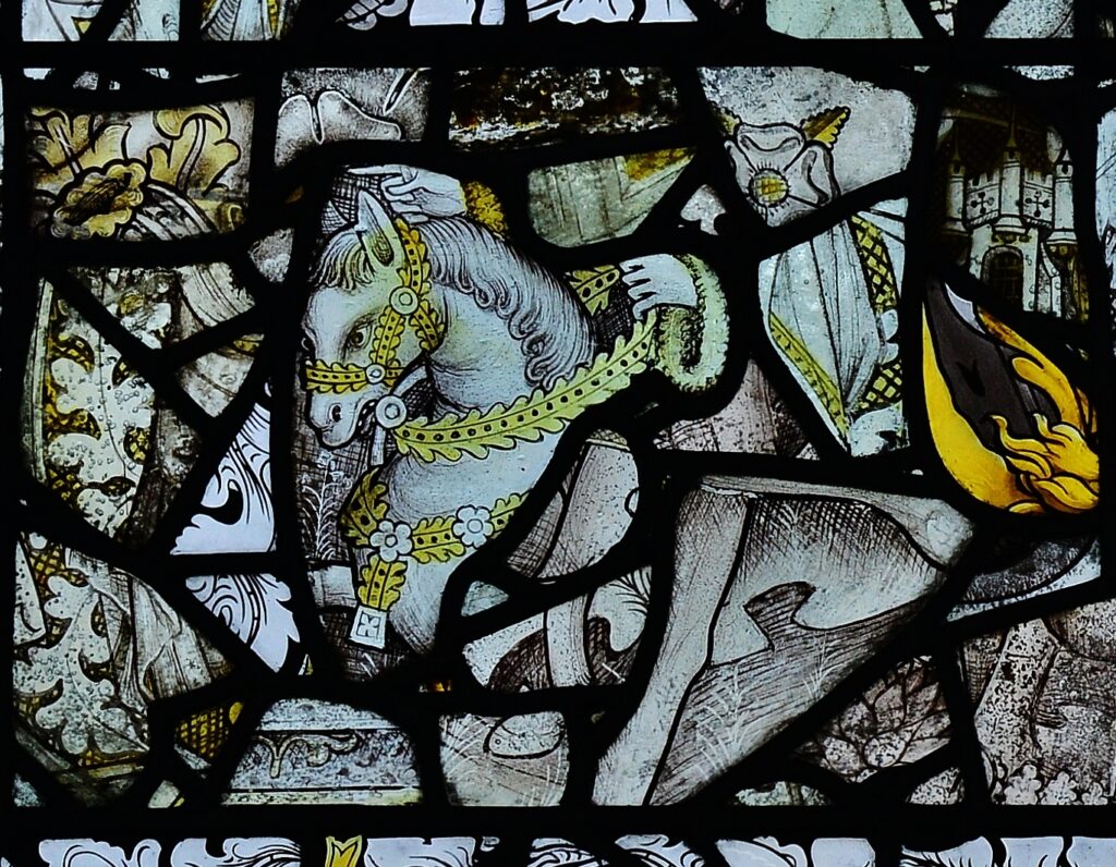 Medieval stained glass window featuring galloping horse at St. Mary's Church, Mendlesham