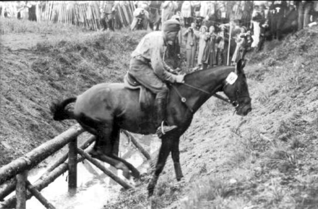 Equestrian Olympics 1956, Sergeant Petrus Kastenman on Iluster passes the much-discussed obstacle no. 22 on the field event's terrain test out on Järvafältet, north of Stockholm.