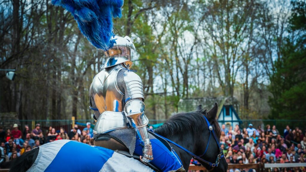 a man dressed in armor riding on the back of a horse