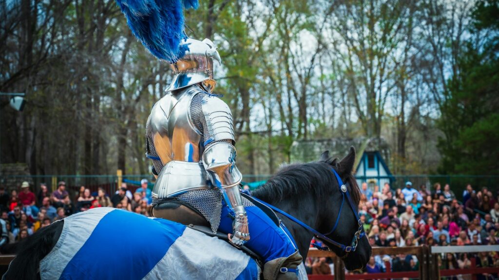 a man dressed in armor riding on the back of a horse