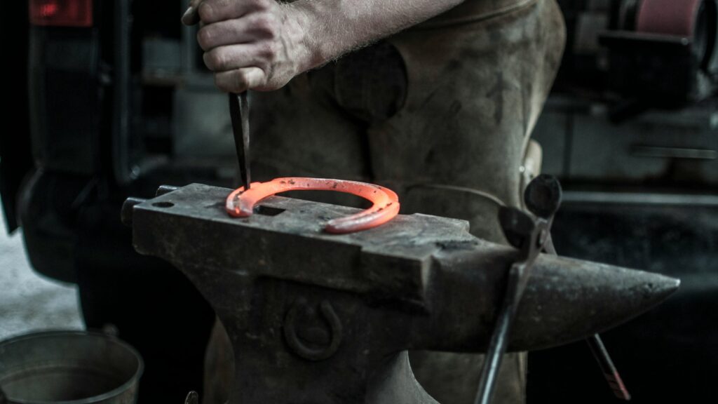 man forging horseshoe