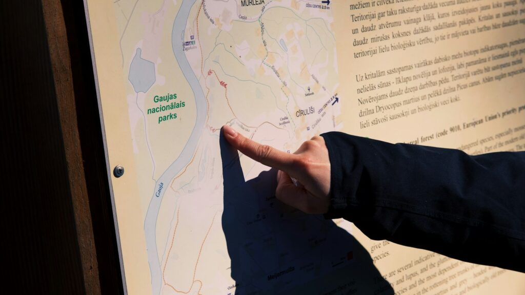 Someone is pointing at a map on a display.