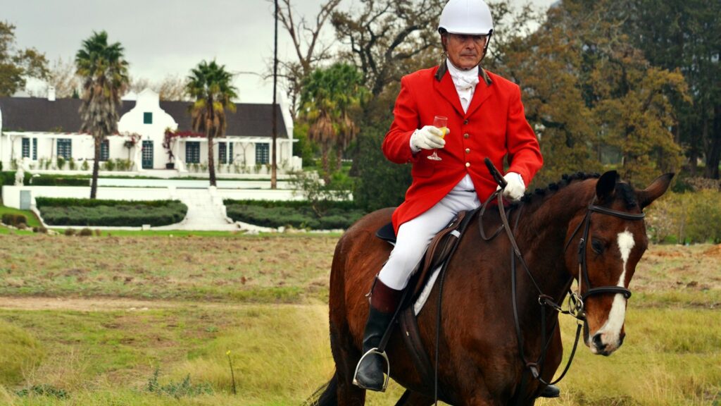 man riding horse on farm during daytime