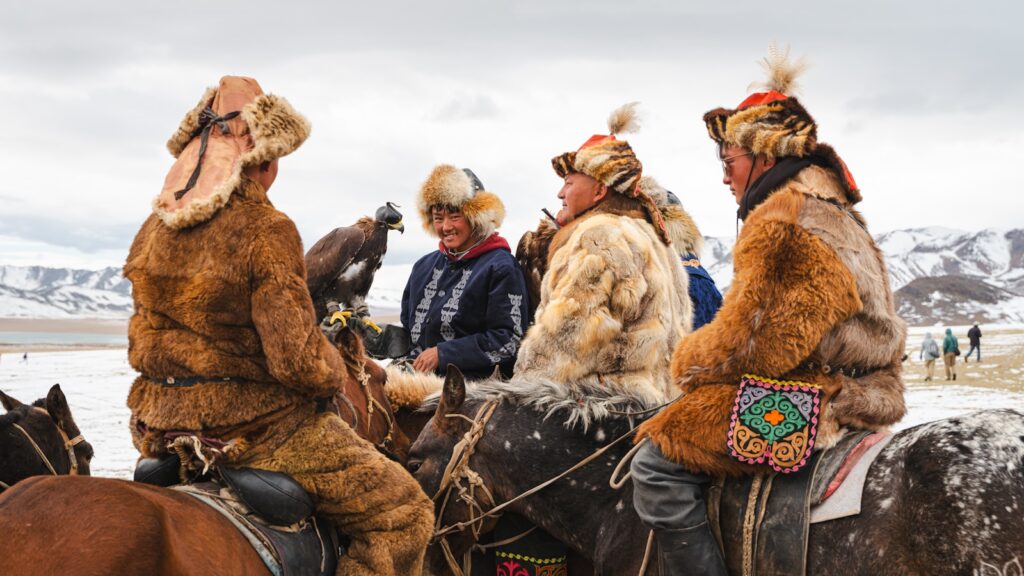 Mongolian eagle hunters on horses during a festival.