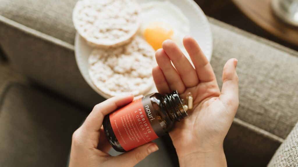 person holding red bottle