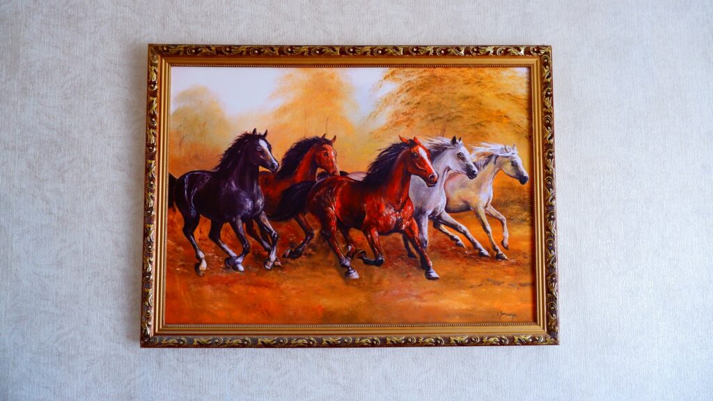 brown wooden framed painting of horses