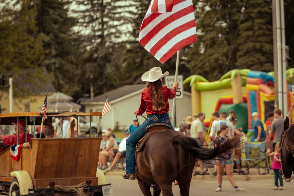 A person riding a horse with a flag on it