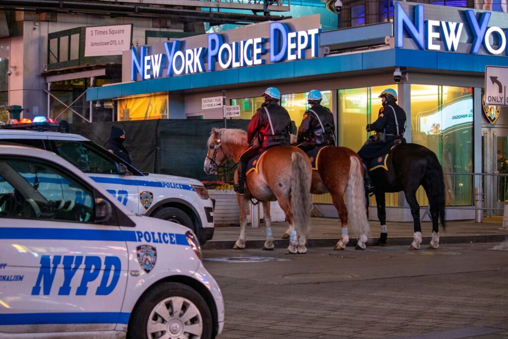 A group of police officers riding on the backs of horses
