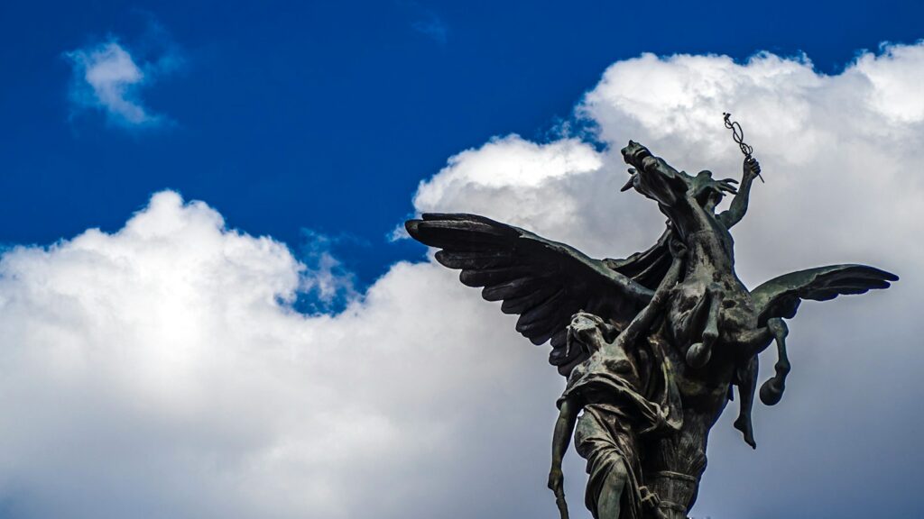 black angel statue under blue sky during daytime