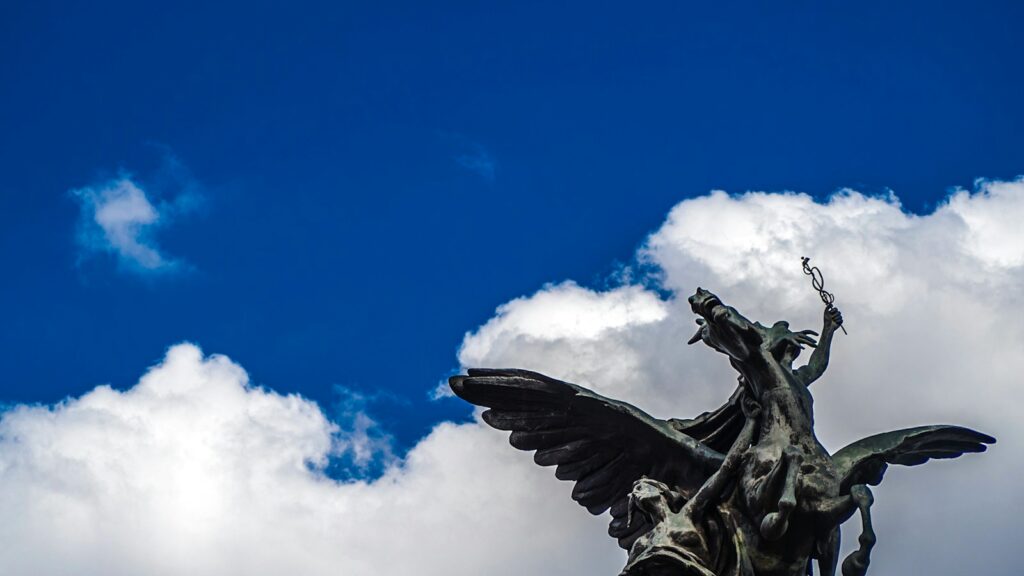 black angel statue under blue sky during daytime