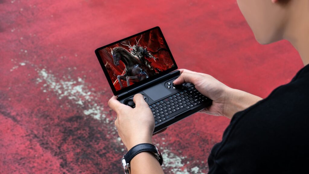 A woman holding a laptop computer with a dragon on the screen