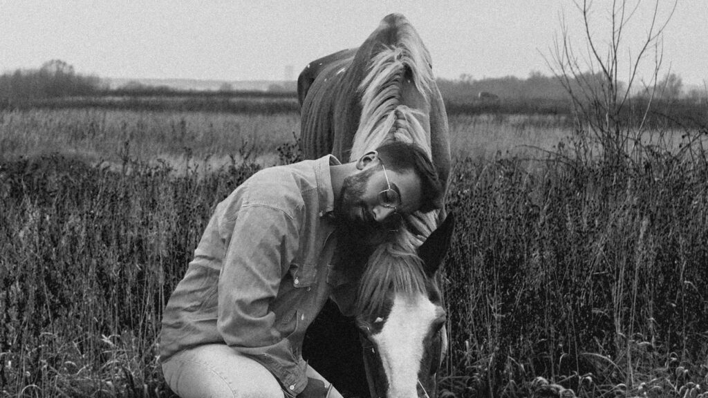 woman in jacket sitting on grass field