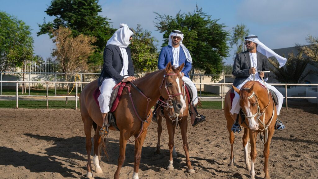 A group of people riding on the backs of horses