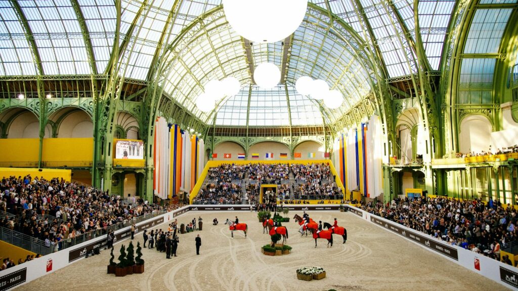 people riding horses in stadium