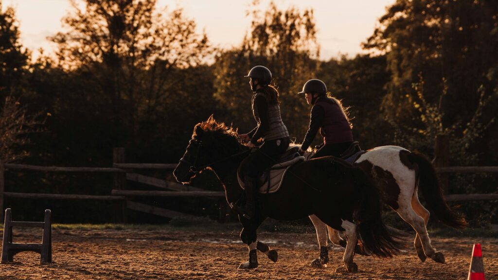 a couple of people riding on the back of horses