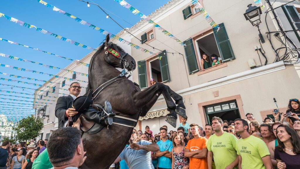 man riding house between people and building