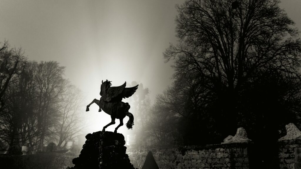 man riding horse statue near trees during daytime