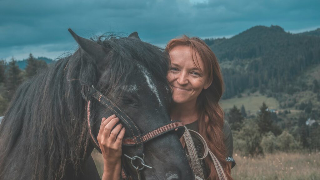 woman holding horse