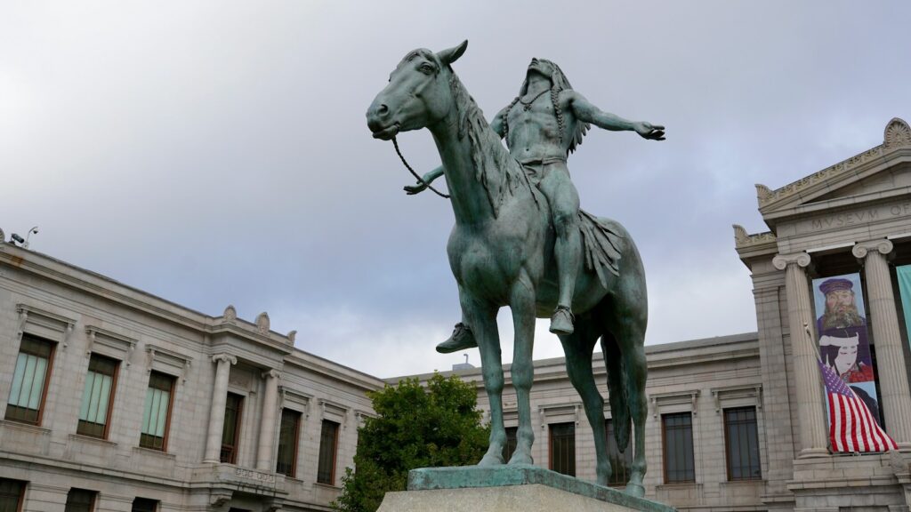 a statue of a person riding a horse