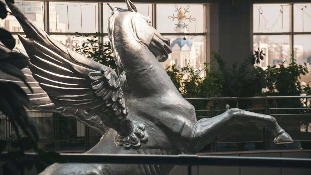 A silver pegasus statue stands tall and proud.