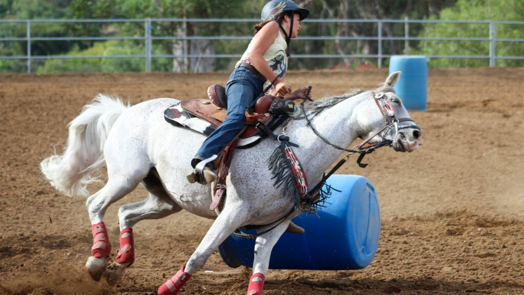 woman riding horse during daytime