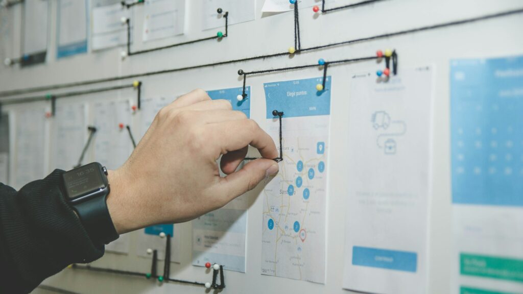person working on blue and white paper on board