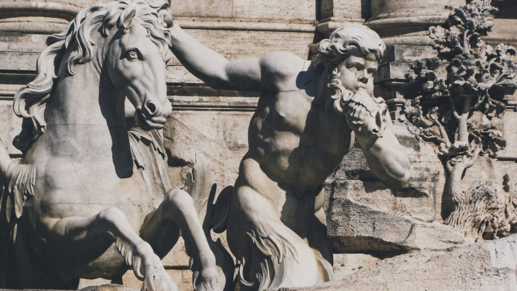 a statue of a man riding a horse next to a statue of a horse
