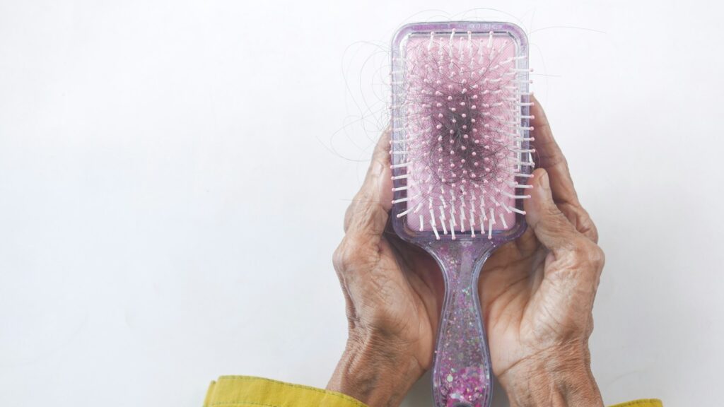 a person holding a hair brush in their hands