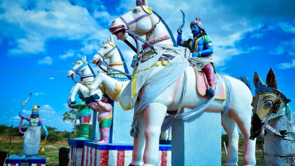 a statue of a man riding a horse next to other statues