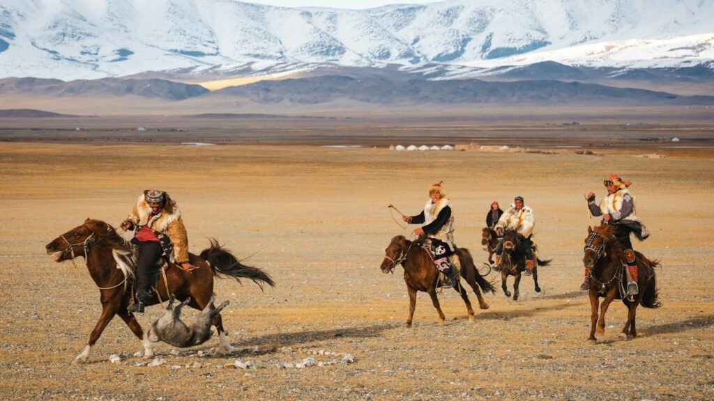 A group of people riding on the backs of horses