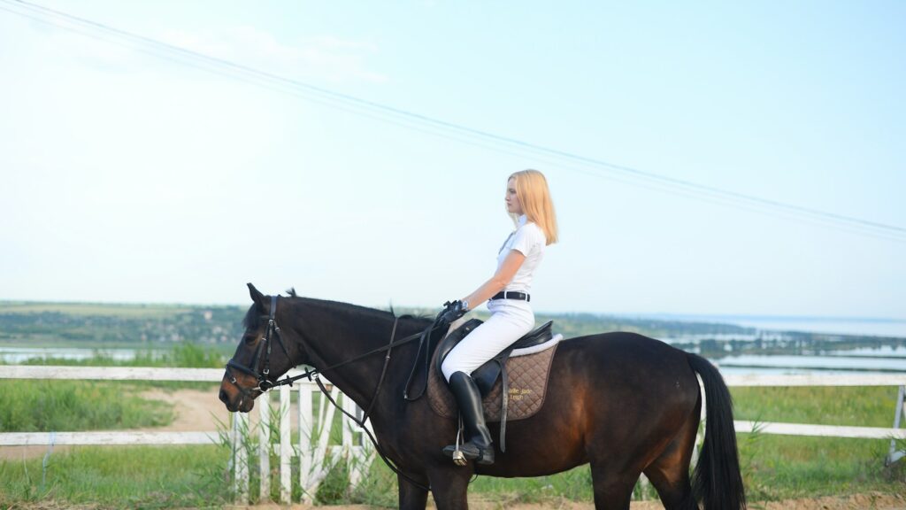 woman riding horse during daytime