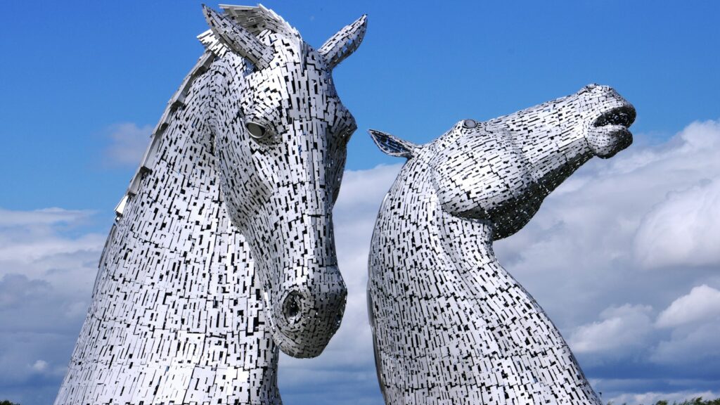 two large metal horses standing next to each other