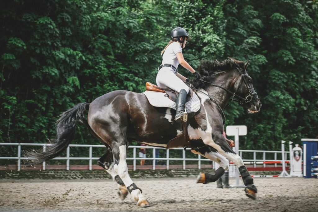 Woman riding on horse near trees