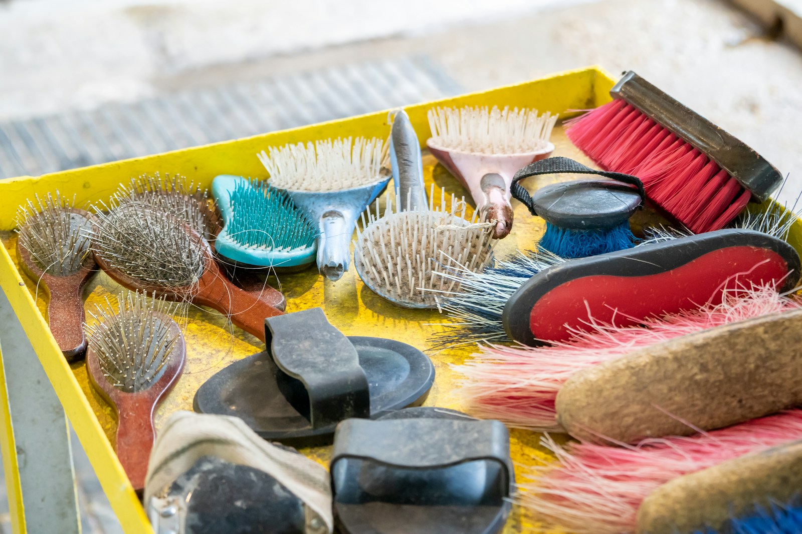 A yellow box filled with lots of different types of brushes
