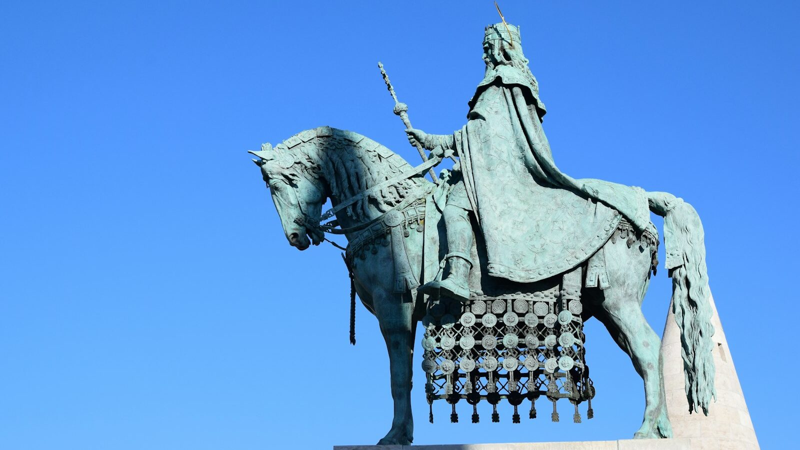 low-angle photography of man riding horse statue under calm blue sky