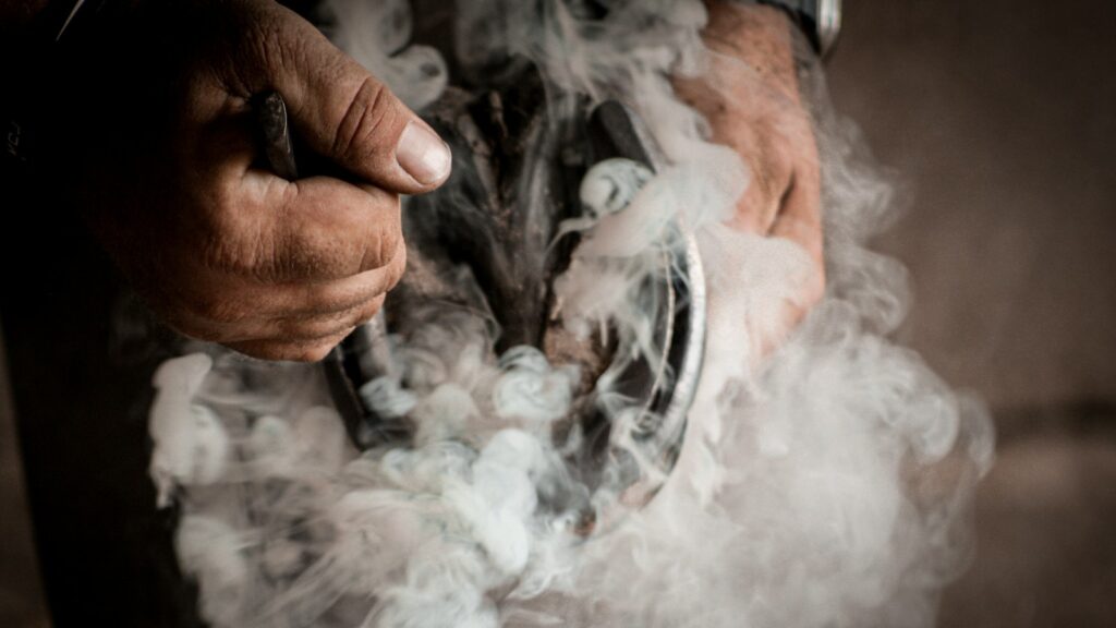 A person holding a cigarette in their hands