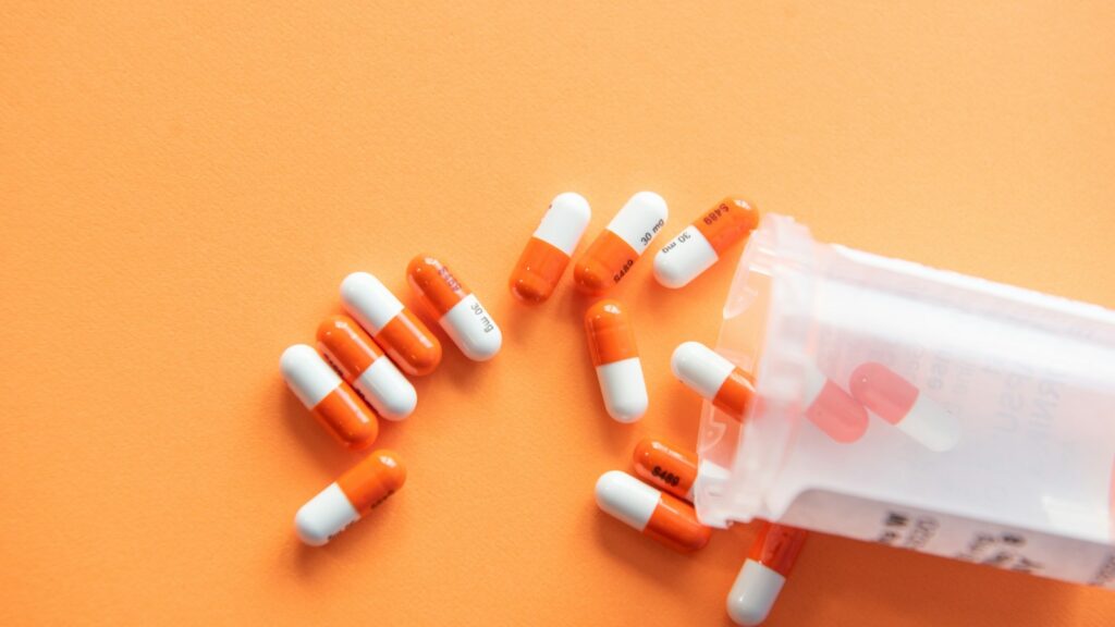 orange and white medication pill