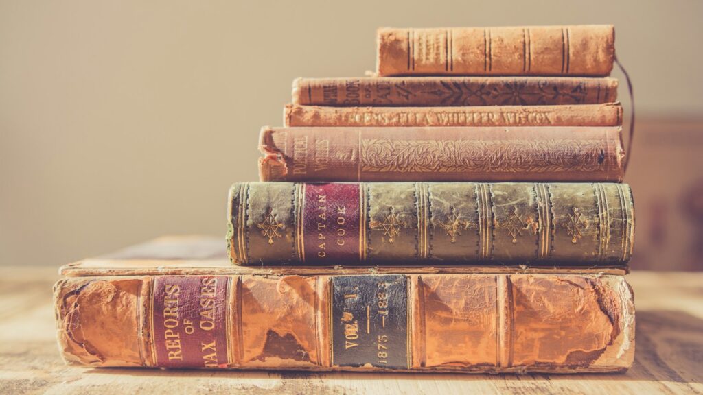 shallow focus photography of stack of books