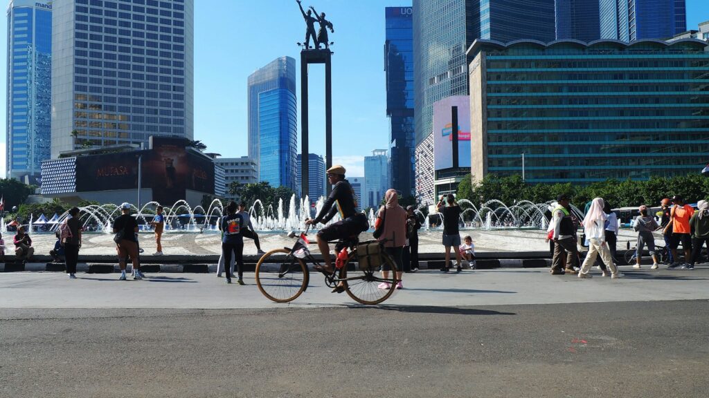 A group of people riding bikes down a street