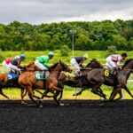 Horse racing action with jockeys and horses competing on racetrack in Erie, PA.
