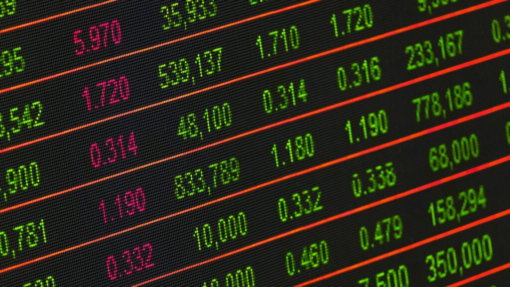 Close-up of a digital stock market data display showing colorful financial numbers and trends.