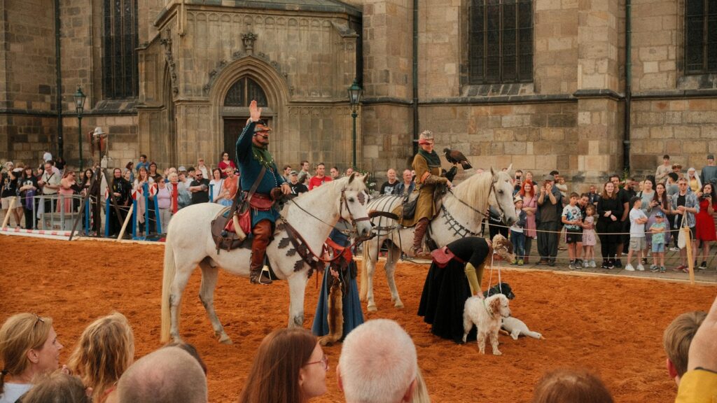 Medieval horseback riders perform for an audience.