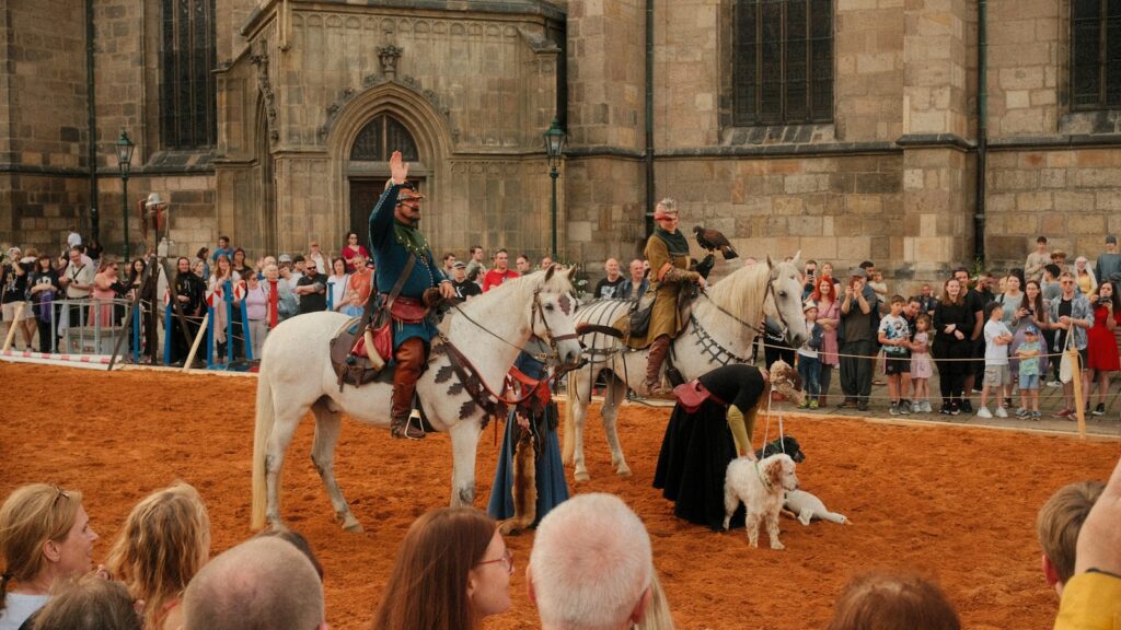 Medieval horseback riders perform for an audience.