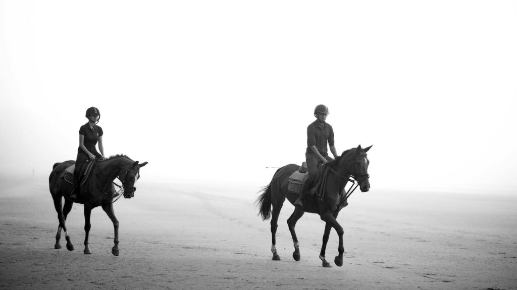 Riders on horseback at the beach in Nargol, Gujarat.