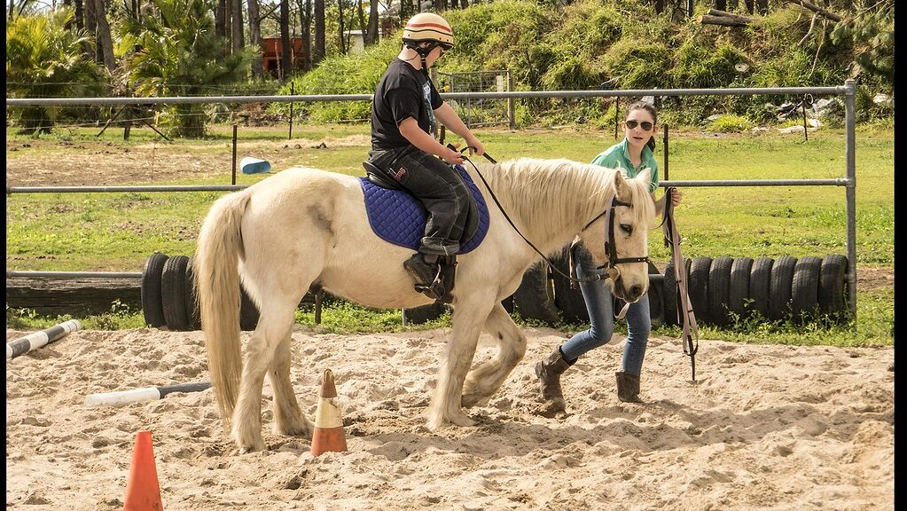 instructor is guiding rider