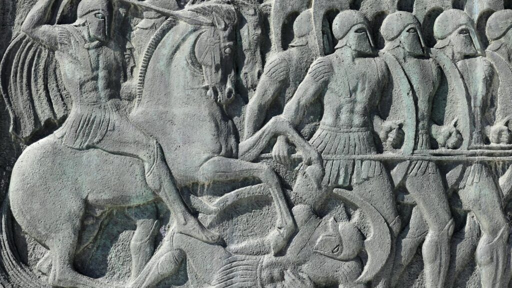 Intricate stone relief depicting an ancient Greek battle scene in Thessaloniki, Greece.