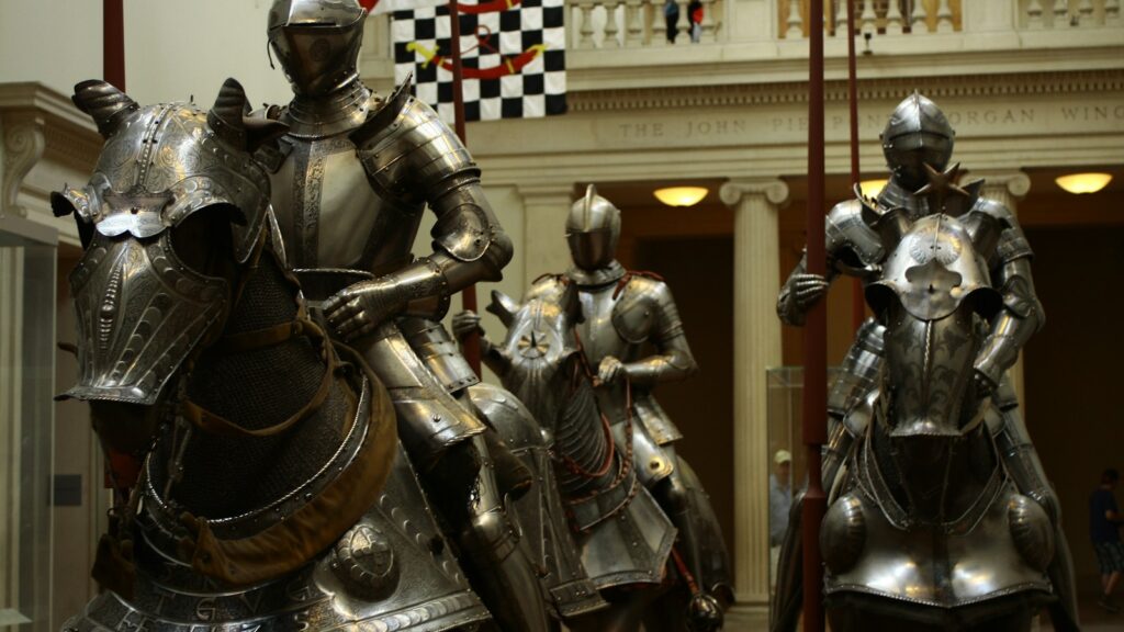 3 men in gold and black suit statue