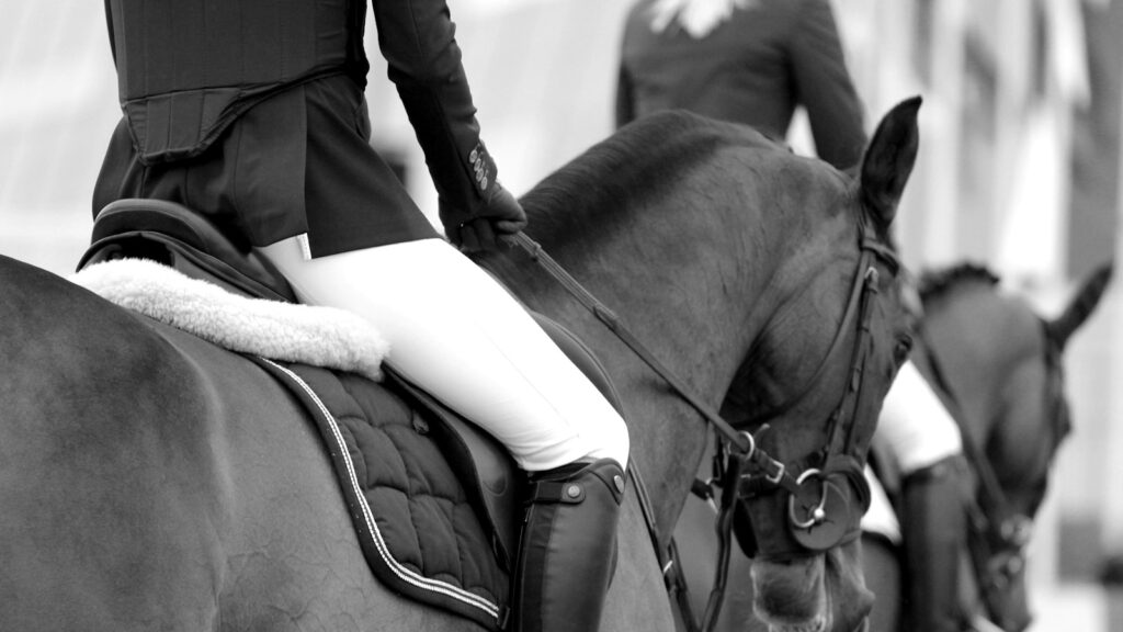 grayscale photography of woman riding on horse
